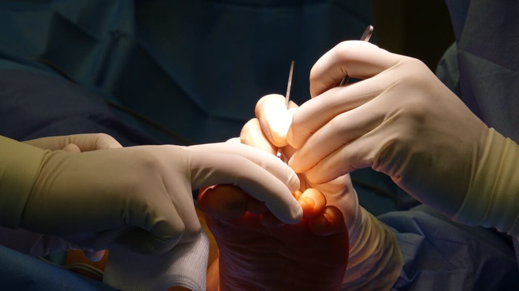 pexels photo 30798659 Gloved hands performing intricate foot surgery in a sterile operating environment.